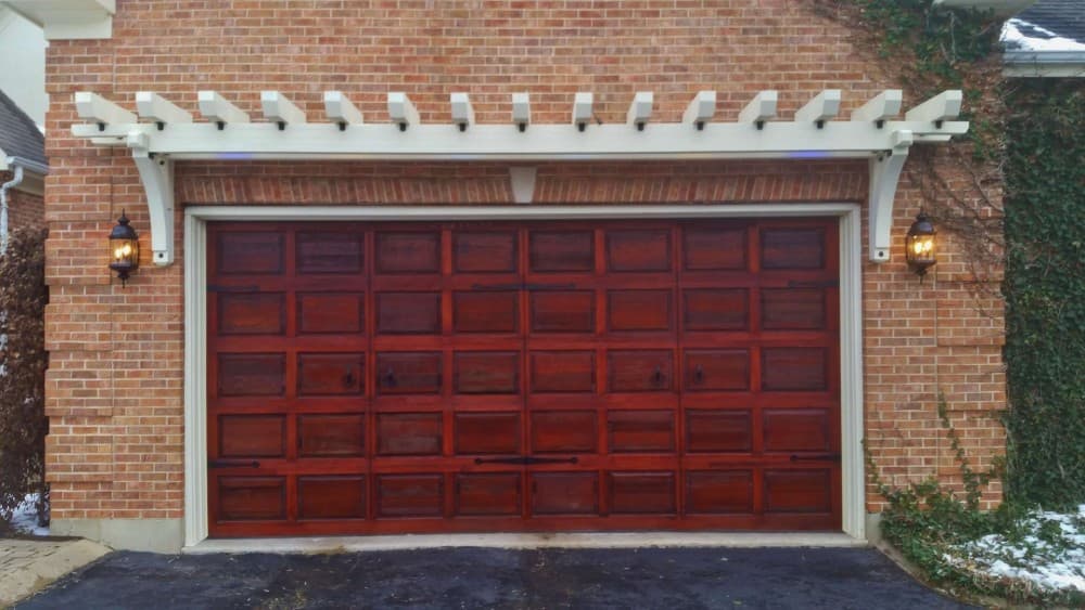 red garage door with red brick house