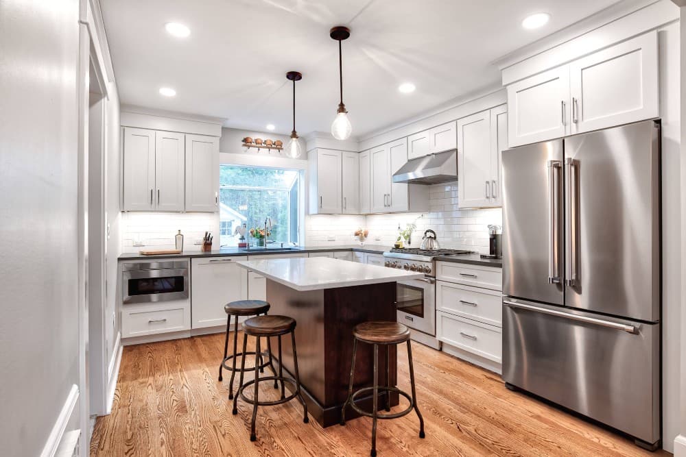 stainless steel appliances with white cabinets