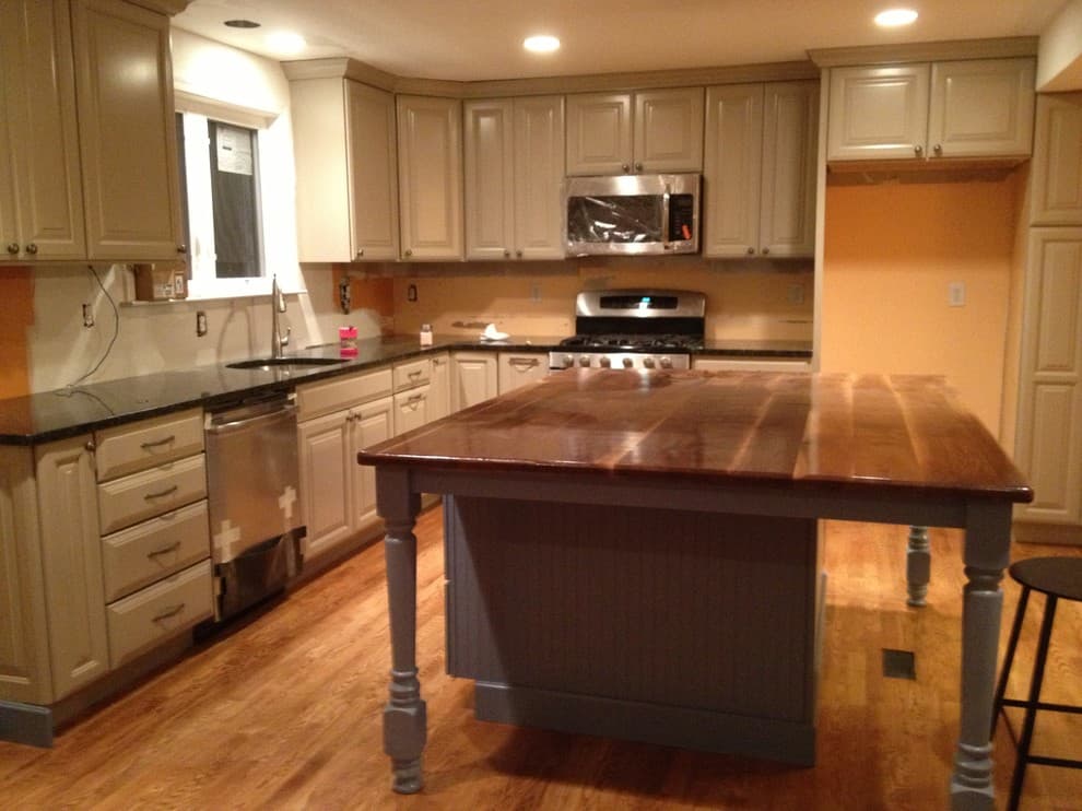 taupe cabinets with brown granite countertops
