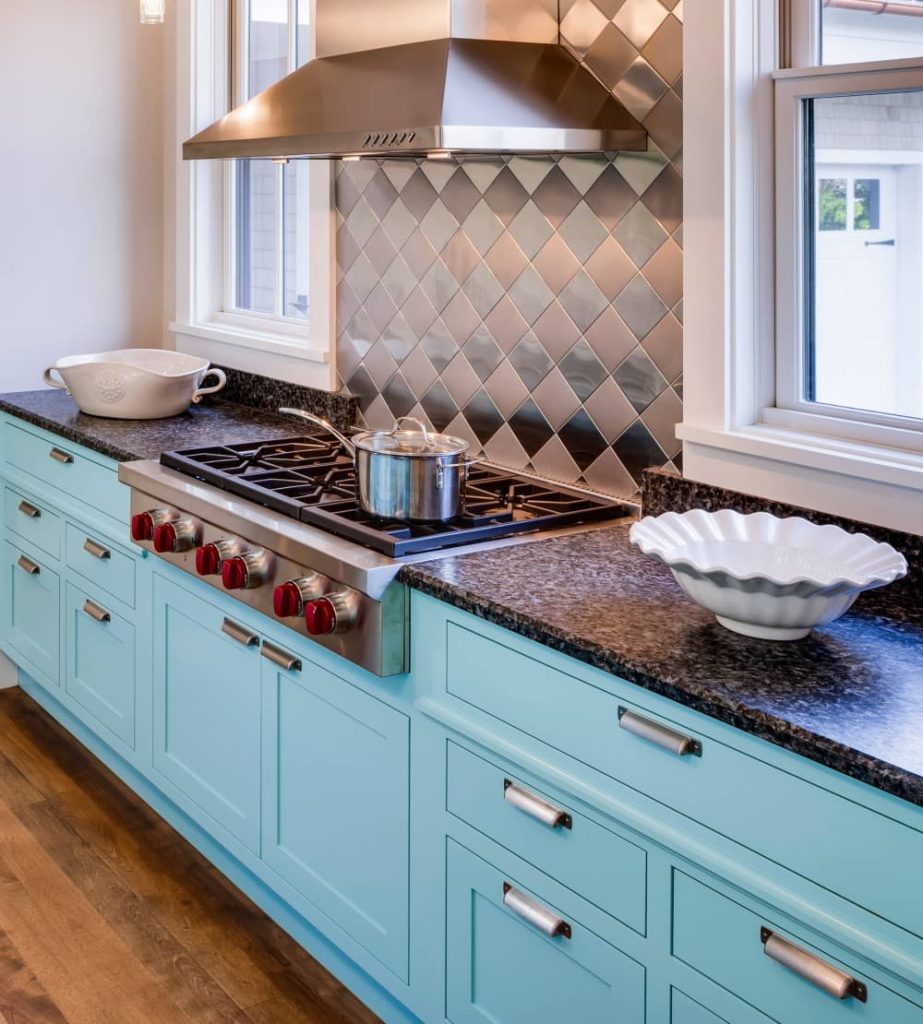 teal cabinets with brown granite countertops