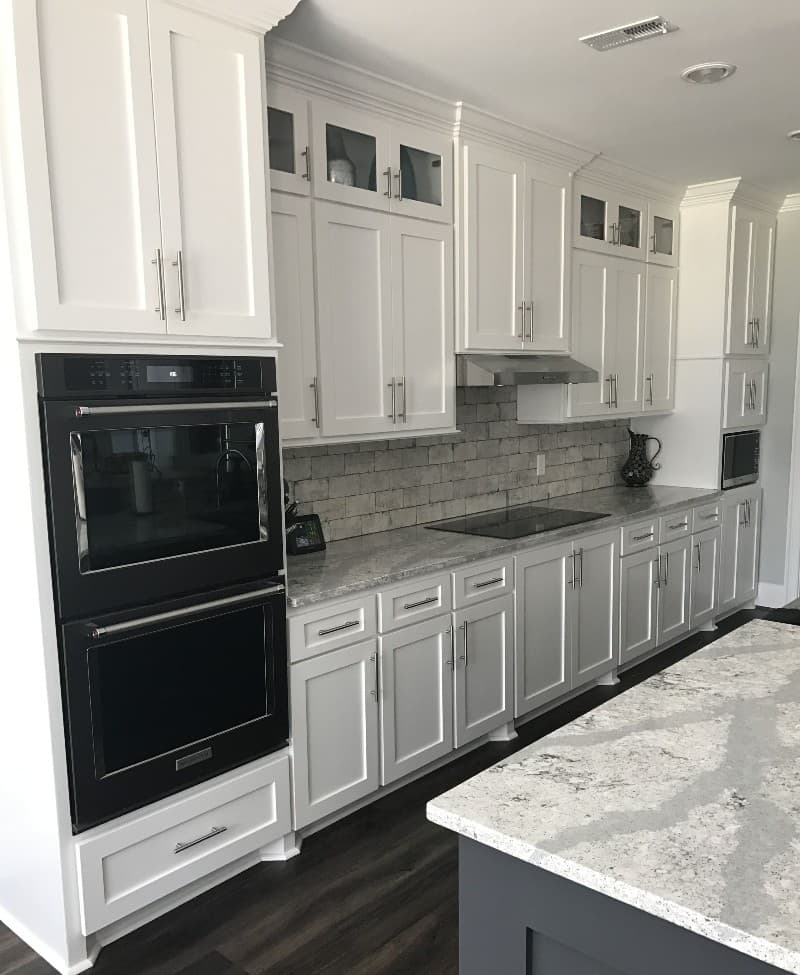 white cabinets with black stainless steel appliances