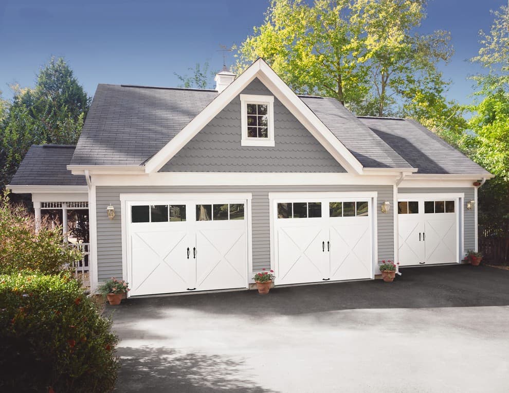 white garage door with gray house