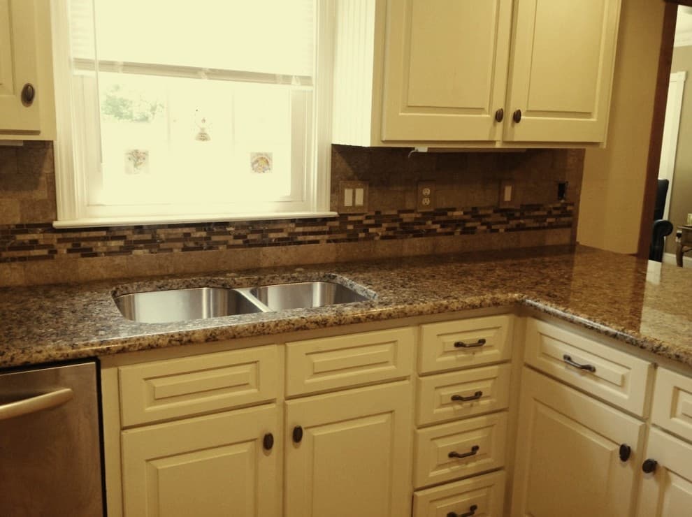 yellow cabinets with brown granite countertops