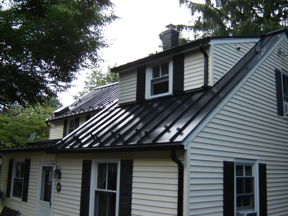 black metal roof with gray siding