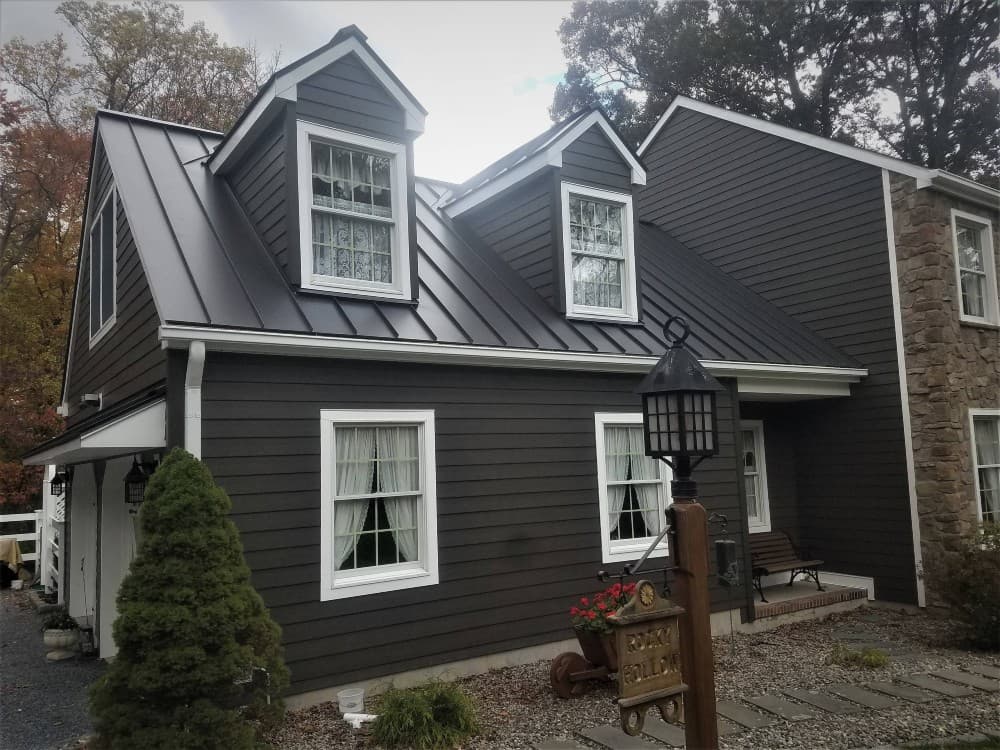 bronze metal roof with gray siding
