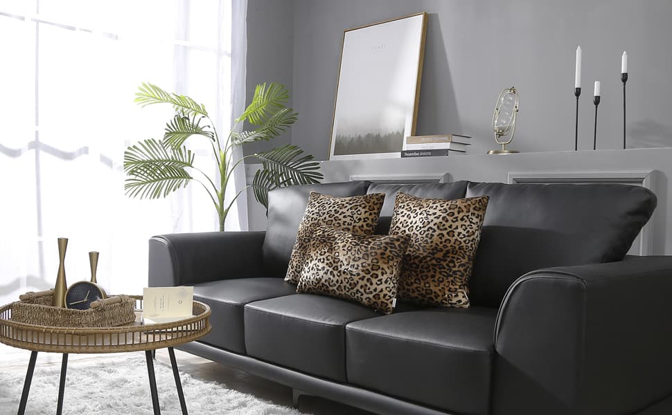 cheetah pillows with black leather couch