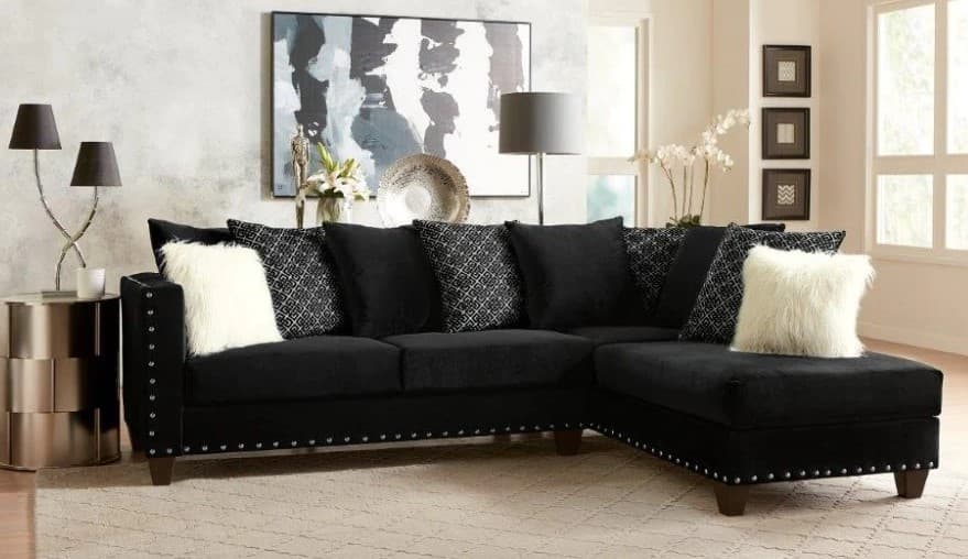 cream pillows with black leather couch