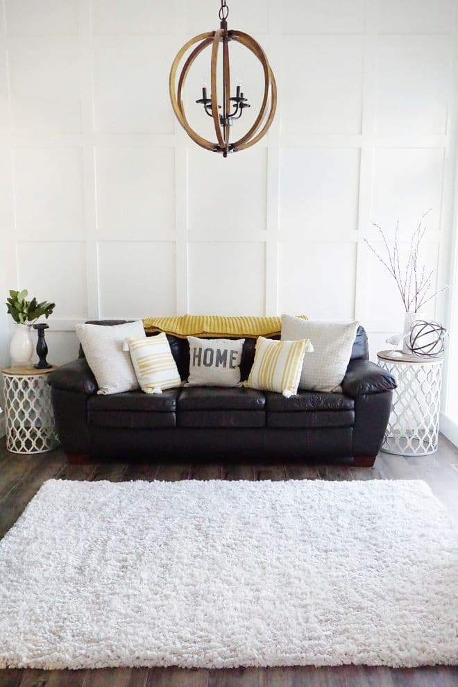 white pillows with black leather couch