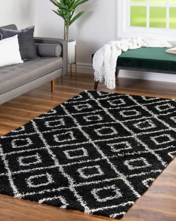 black and white rug with black furniture