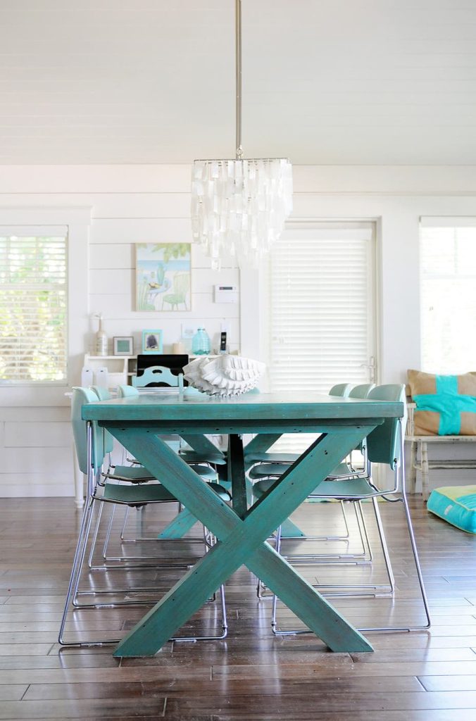 blue dining table with dark wood floors