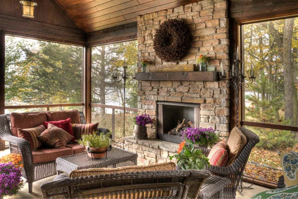 rustic screened in porch with fireplace