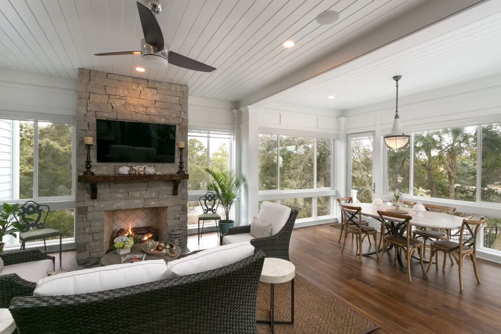 screened in porch with fireplace and tv 1