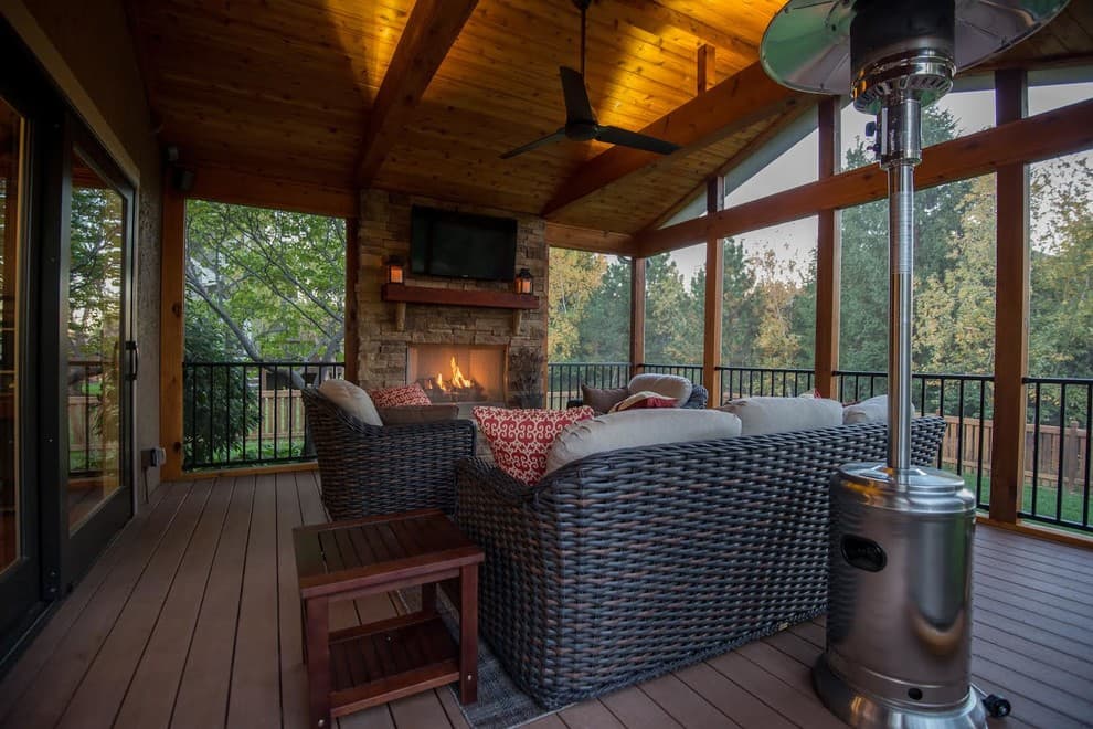 screened in porch with fireplace and tv