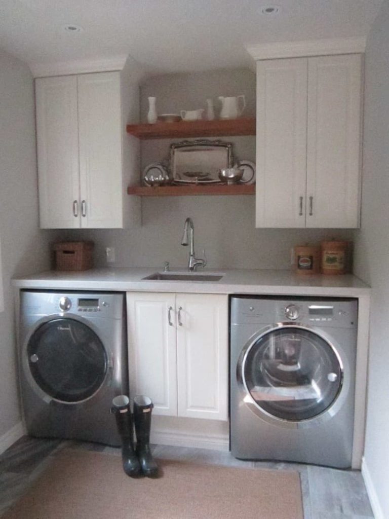 laundry room with sink between washer dryer