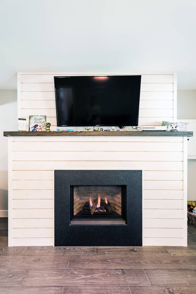 shiplap accent wall with tv and fireplace