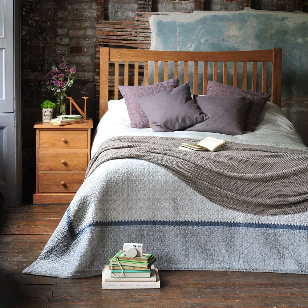 gray bedding with oak furniture