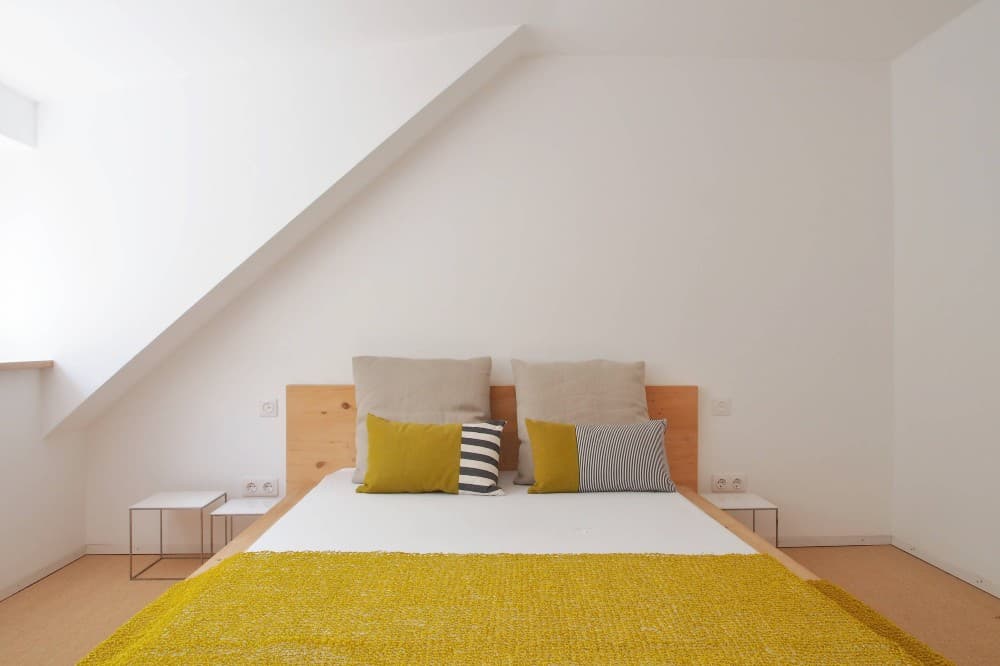 gray yellow bedding with oak furniture