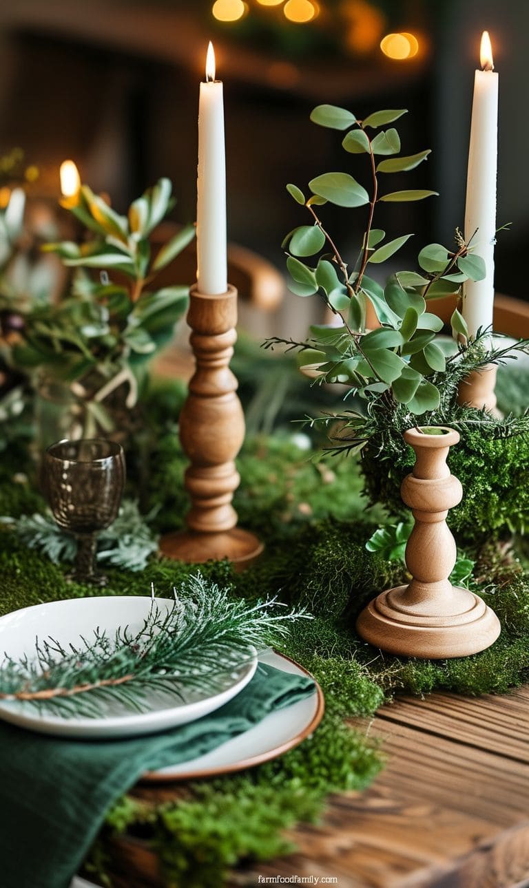 Woodland-inspired table decor with moss table runner, wooden candle holders, and forest greenery.
